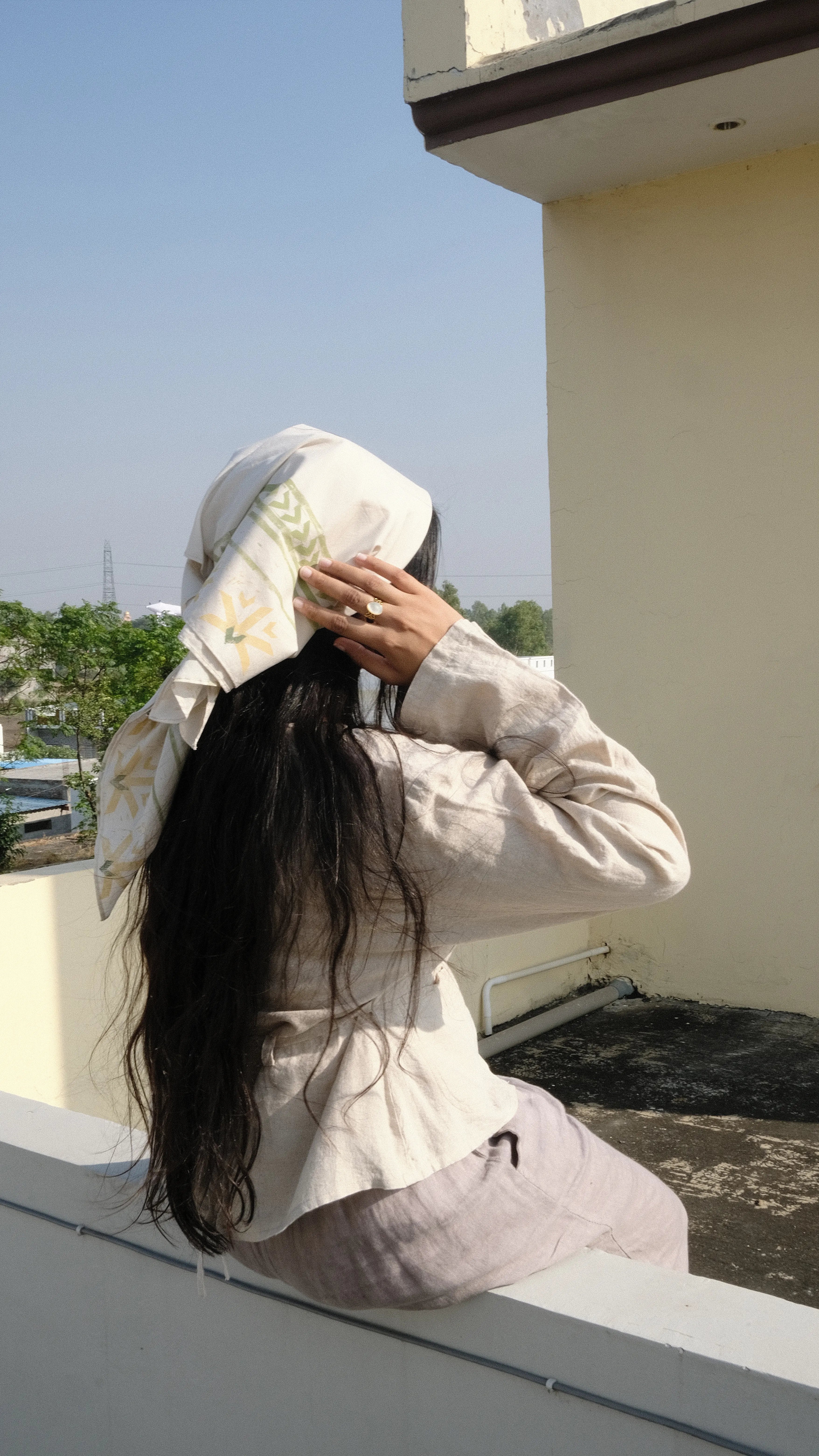 girl styling her scarf on holiday