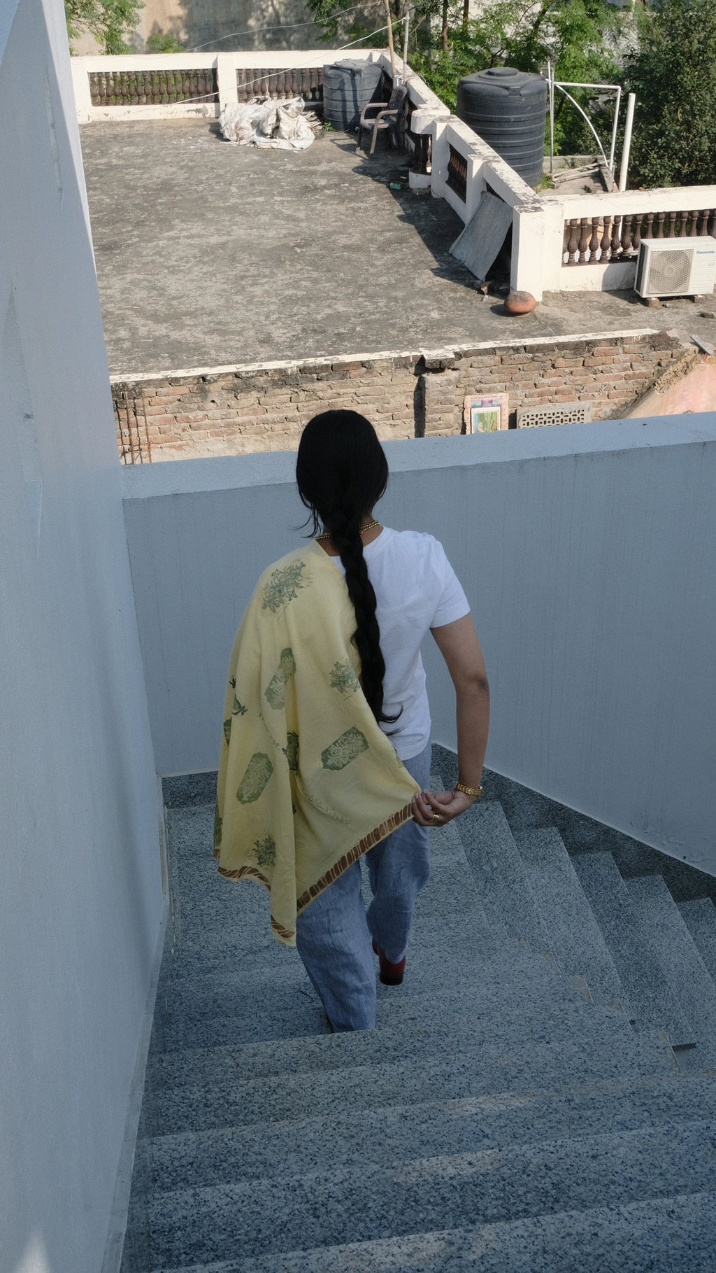 Girl walking down the stairs wrapped in her scarf