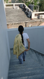 Girl walking down the stairs wrapped in her scarf