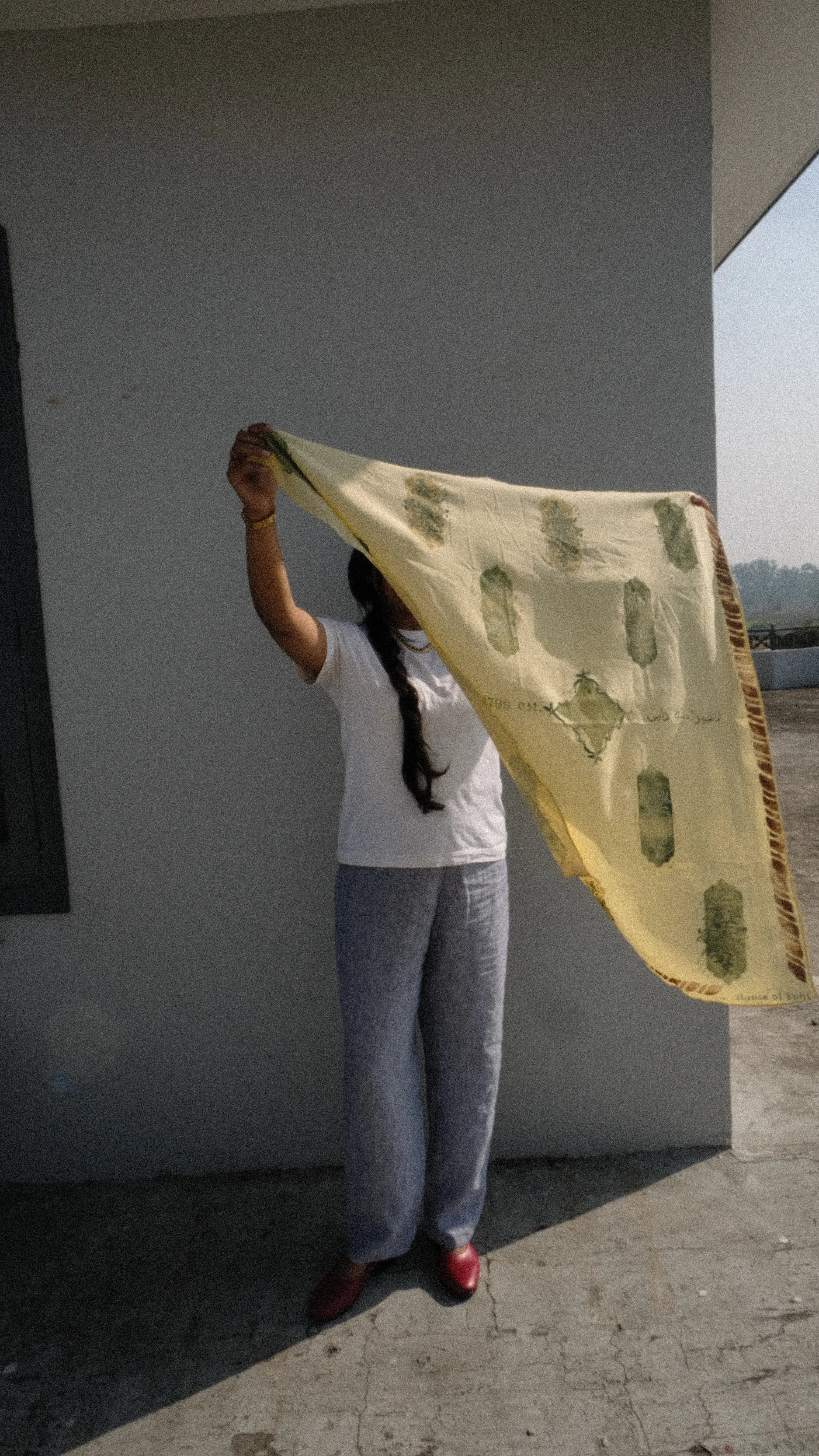 girl waving her scarf about in the sun on a rooftop in panjab
