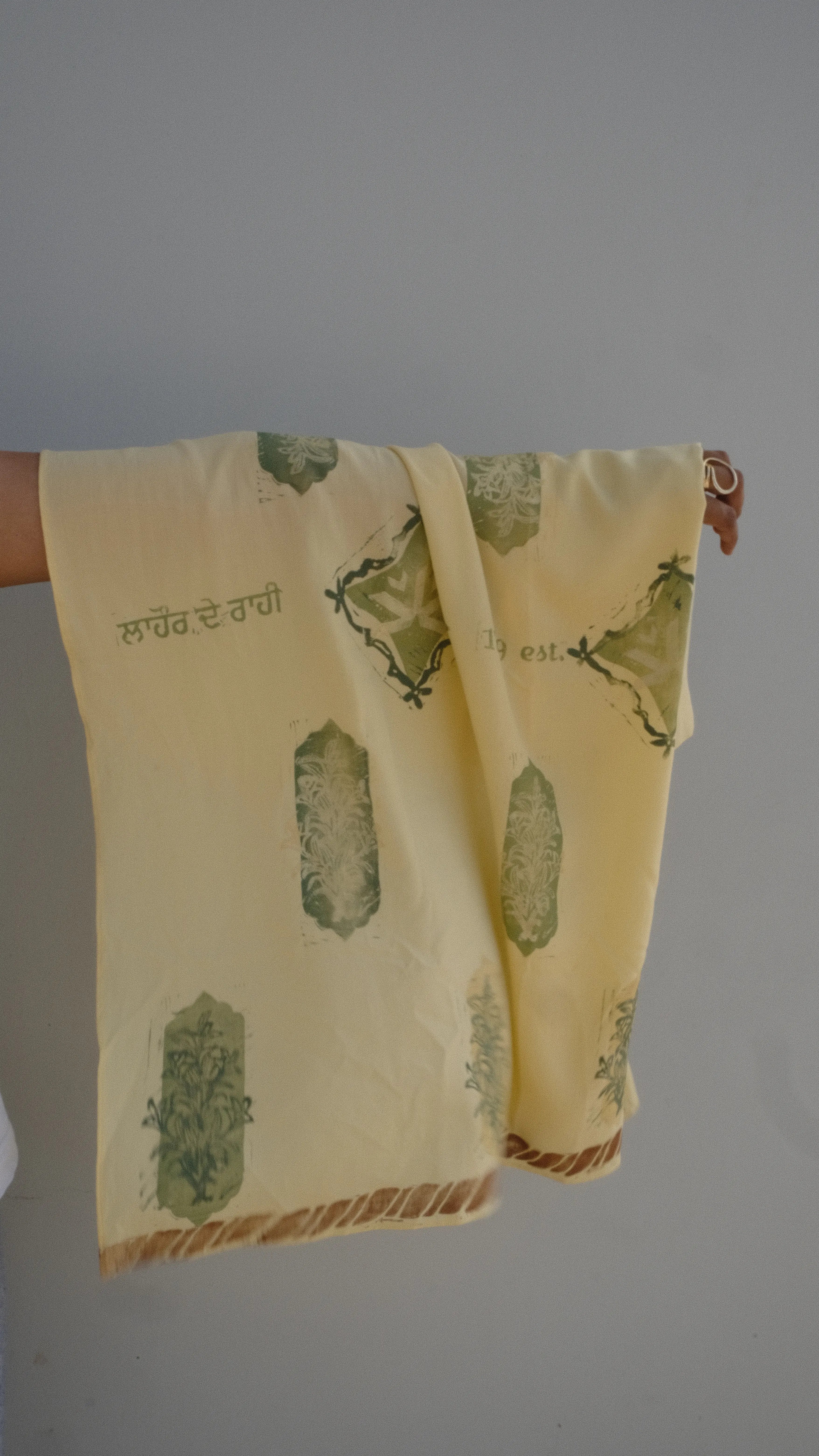 handprinted scarf draped on the arm as a heritage display