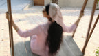 girl swinging outside wearing a headscarf