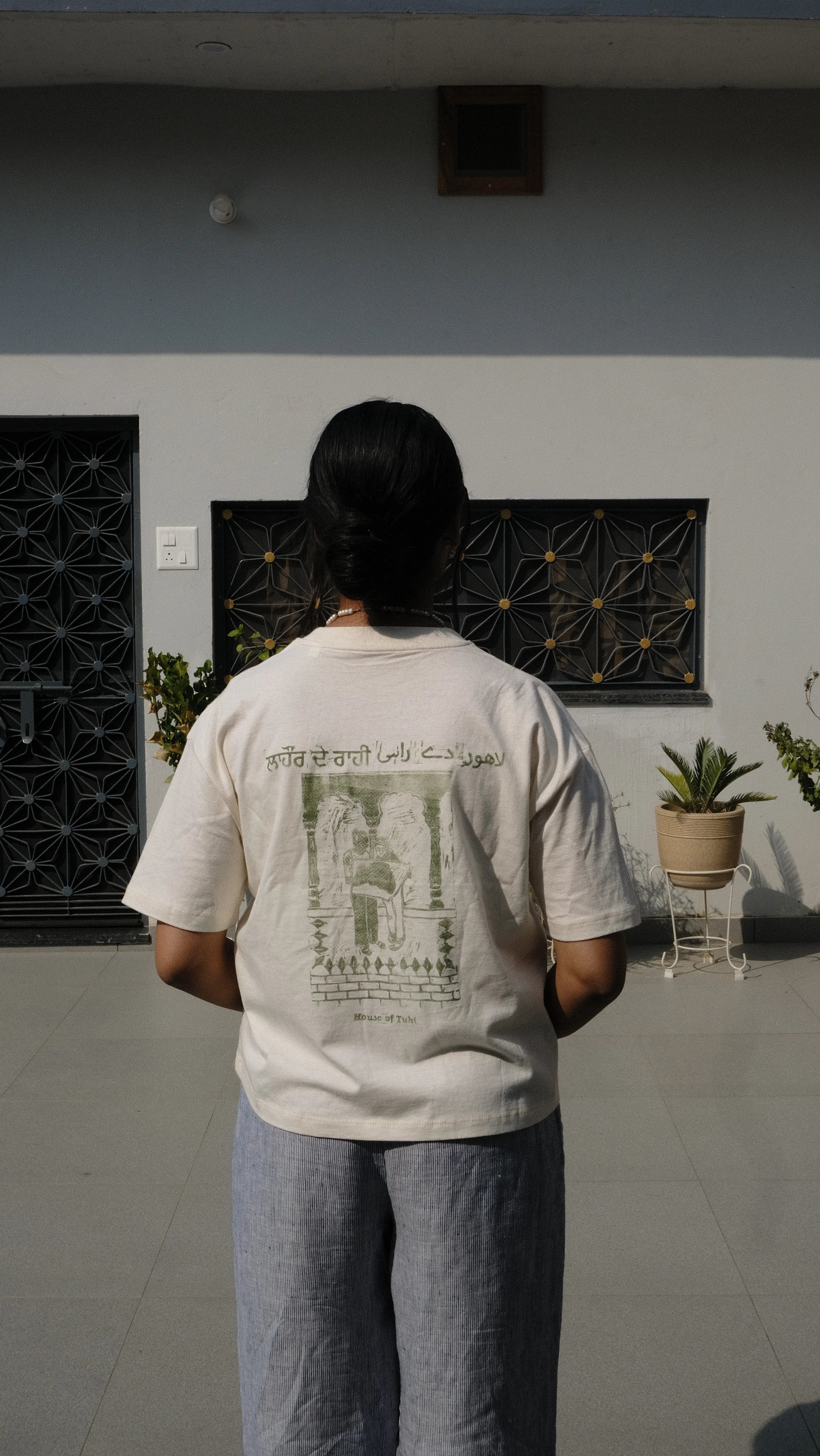 handprinted tshirt girl standing in panjabi courtyard