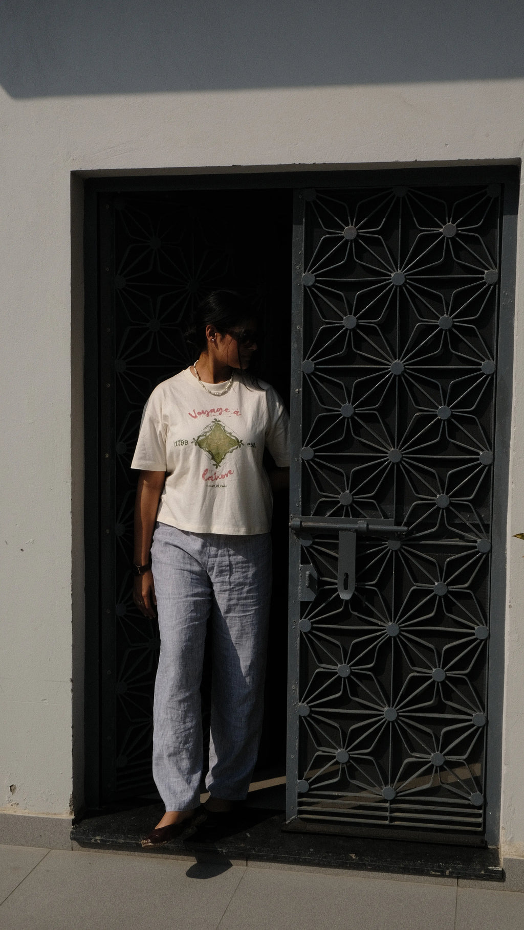 girl styled in handprinted tshirt in a courtyard in panjab