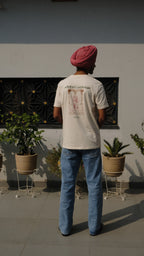man wearing a handprinted tshirt standing in a panjabi courtyard