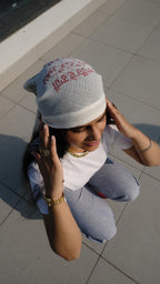 Girl hiding her face away from the sun using a scarf as protection