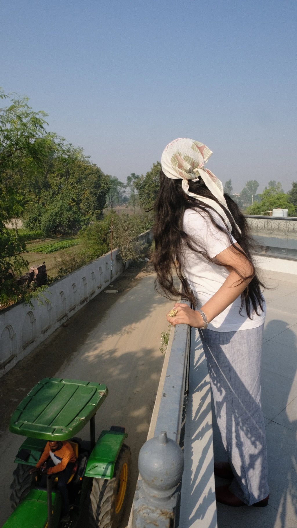 Girl looking over the balcony to the city 