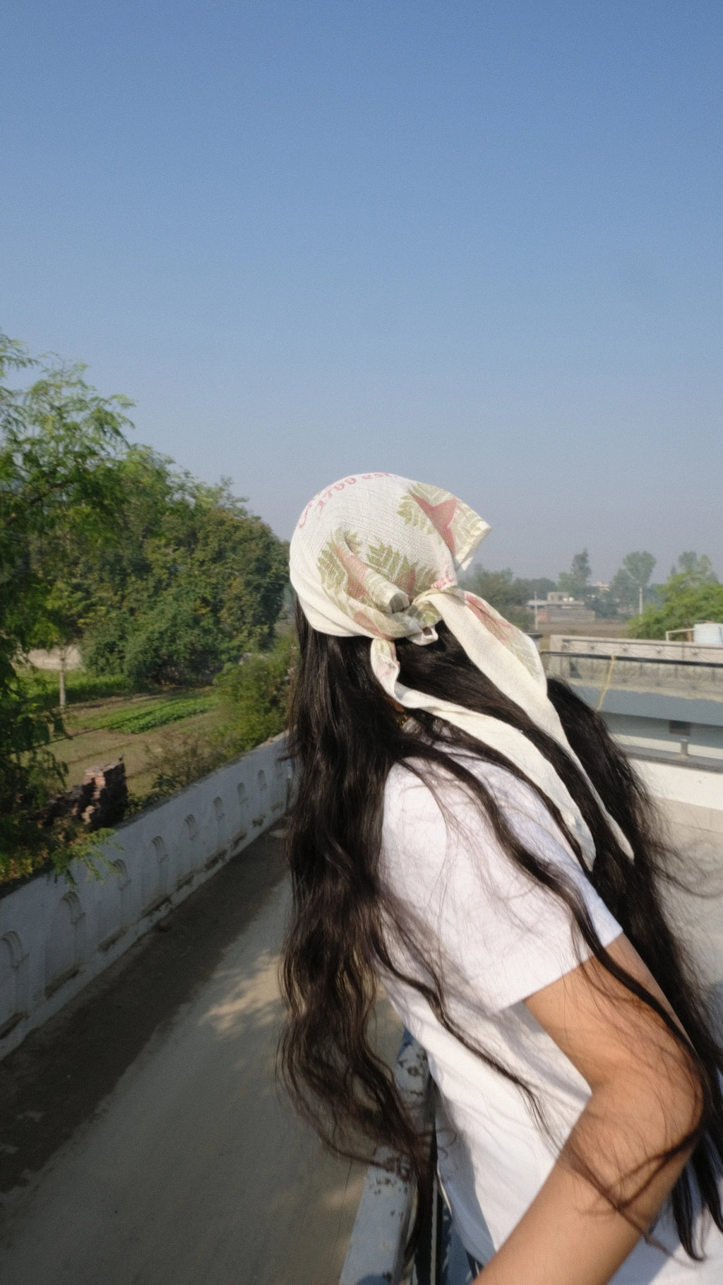 Girl looking over the balcony into the city