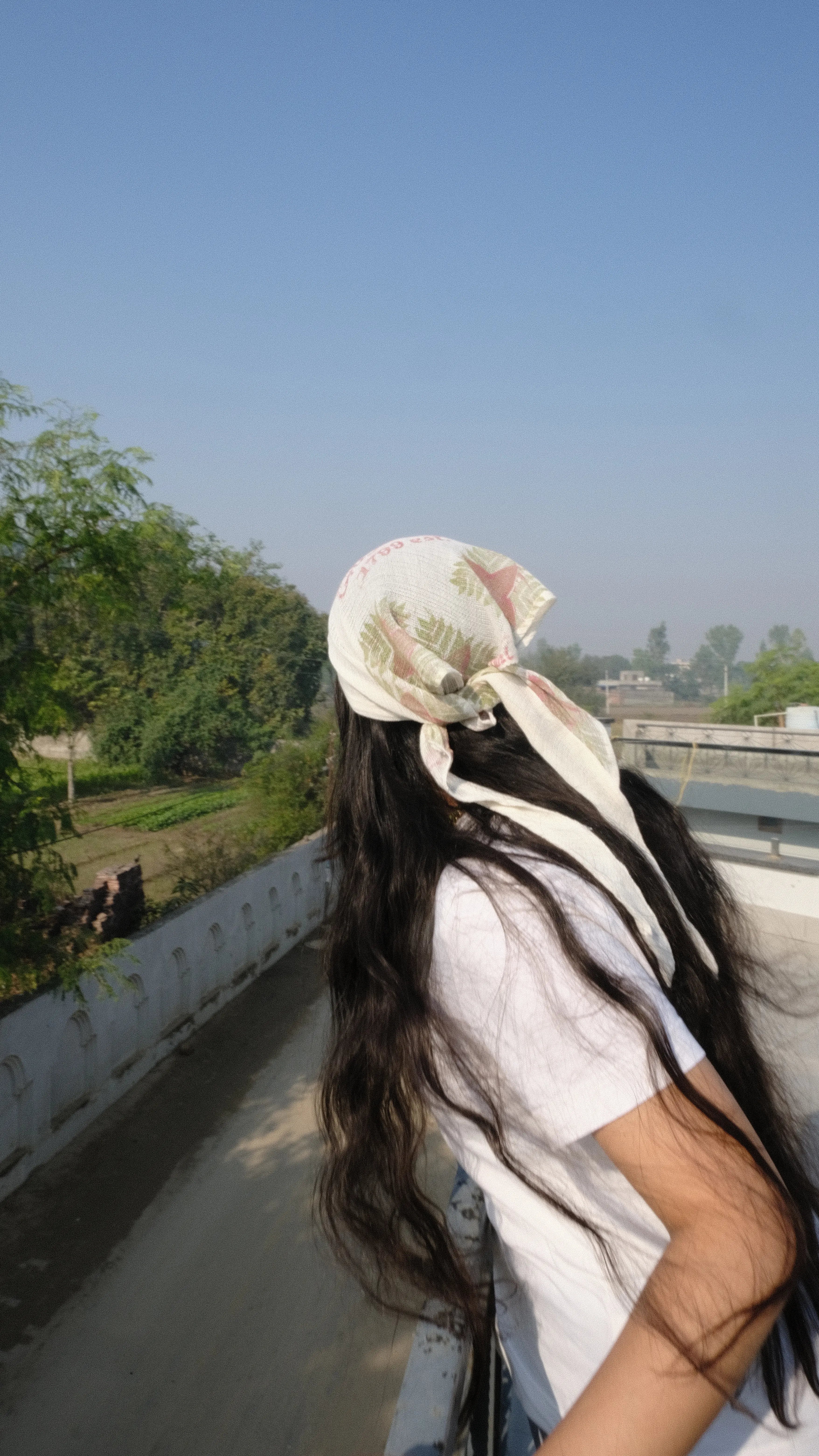 Girl looking over the balcony into the city